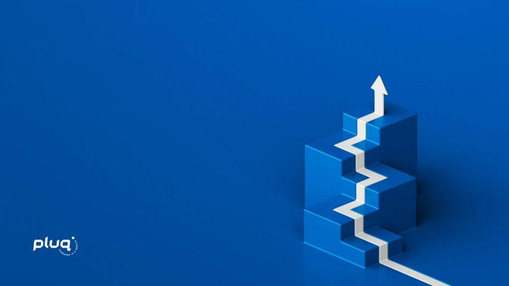 White zigzag arrow rises up blue 3D blocks shaped like stairs, symbolizing growth and progress. The background is solid blue, with the pluq logo in the lower left corner.